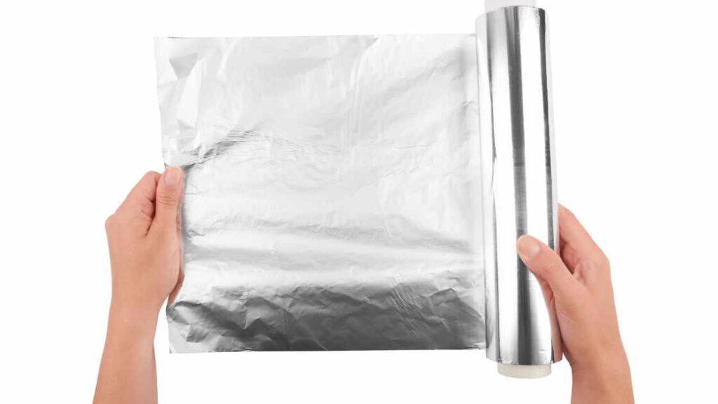 A person holding an aluminum foil substrate representing the query: Why is my sublimation faded ? 