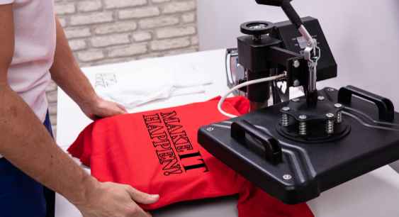 A person printing a red colored shirt with heat press representing the queries: What is DTF Transfer ? Or How to make DTF transfers ? How to make DTF transfer ? Or How to make a DTF transfer ? Types of DTF films . Or How to remove DTF from Shirt ? Or DTF Vs Heat transfer