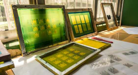 Multiple Screen printing screens lying together in sunlight representing the queries: What is Screen Printing? What are Types of Screen Printing? What is the Process of Screen printing ?