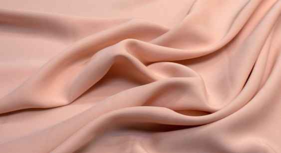 Pink colored polyester fabric representing the queries: What does polyester feel like ? Or Is polyester Clingy ? Or Polyester Vs Other Fabrics. 