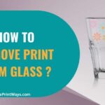 A Glass with flower prints on it representing the queries: How to Remove Print From Glass ? Or How to Remove Printing from glass ? Or How to Remove Printed ink from glass ? Or How to Remove printed ink from glass bottles ? Or How to Remove logo From Glass ?